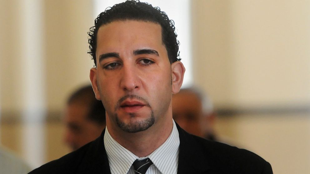 In this April 22, 2013 photo, Andy Ashkar walks towards the entrance to Onondaga County Court in Syracuse, New York, for his trial. 