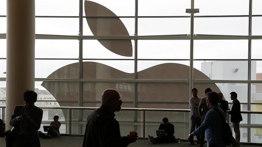 People are shown outside the Apple Worldwide Developers Conference in San Francisco, June 10, 2013.