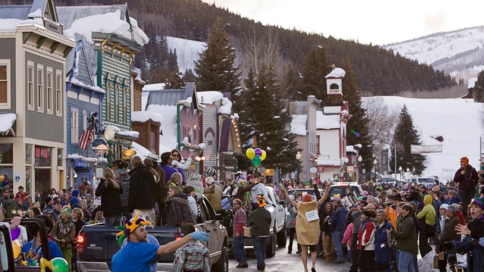 In this Feb. 24, 2009 file photo, a crowd gathers on Elk Avenue in Crested Butte, Colo., during a Mardi Gras parade celebration. 