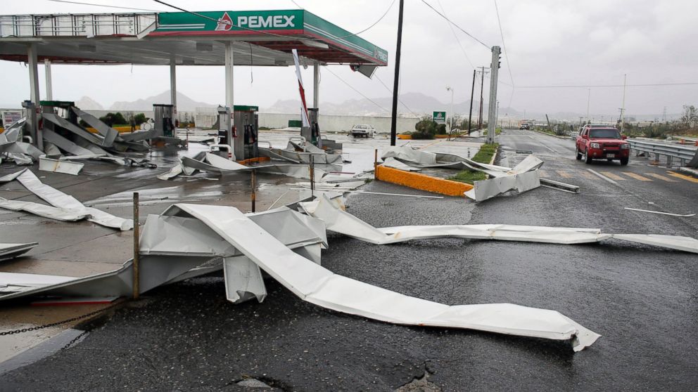 PHOTO: A car drives by a gas station partially destroyed by Hurricane Odile in Los Cabos, Mexico, Sept. 15, 2014.