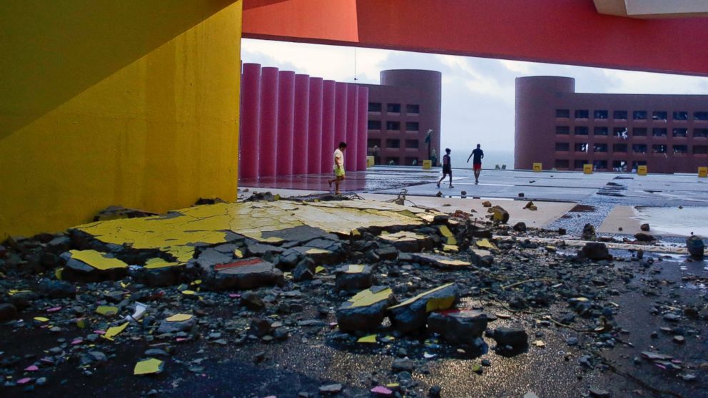 PHOTO: Tourists walks near the entrance of the resort, partially destroyed by Hurricane Odile, in Los Cabos, Mexico, Sept. 15, 2014.