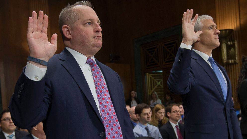 John J. Mulligan, left, executive Vice President and CFO of the Target Corporation, and, right, Michael R. Kingston, senior Vice President and CFO of the Neiman Marcus Group are sworn-in on Capitol Hill, Feb. 4, 2014, in Washington. 