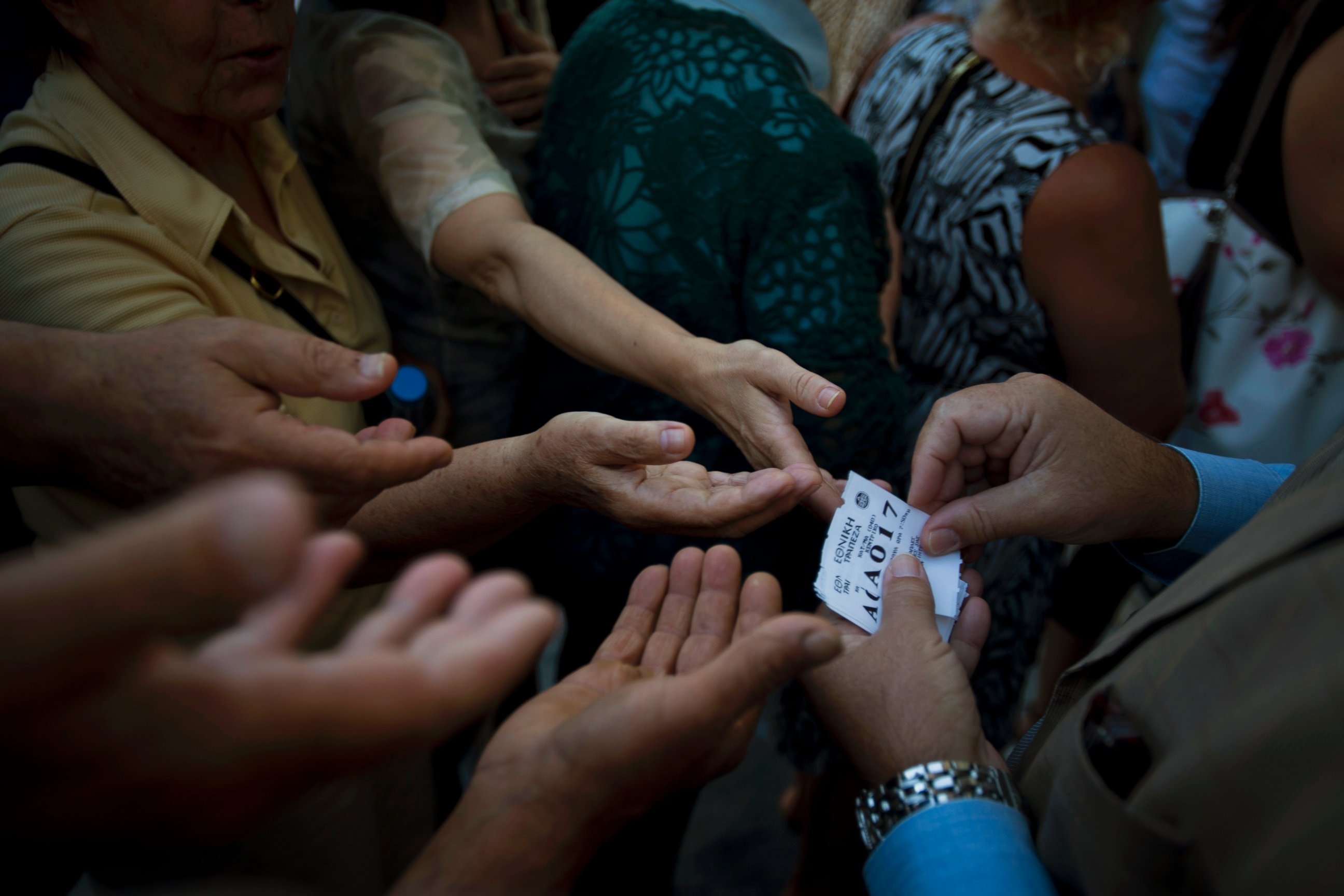 PHOTO: A bank employee distributes tag queue positions to elderly people to enter into the bank to withdraw a maximum of $134 for the week, July 13, 2015, in central Athens.