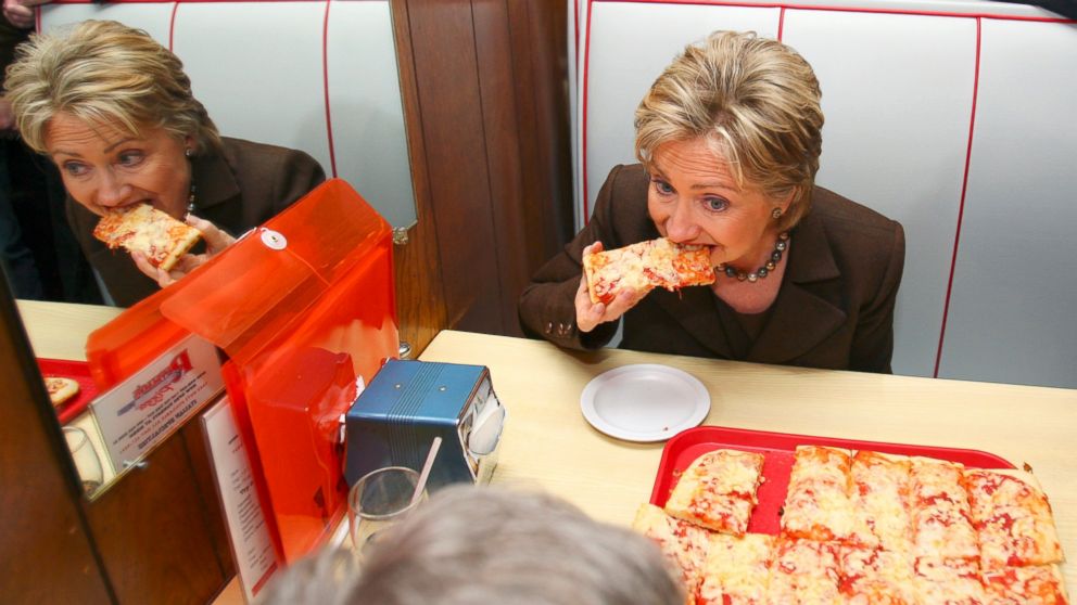 Former Sen. Hillary Rodham Clinton, D-N.Y., eats pizza during a lunch stop at Revello's Cafe Pizzeria, while campaigning in Old Forge, Penn., March 10, 2008.