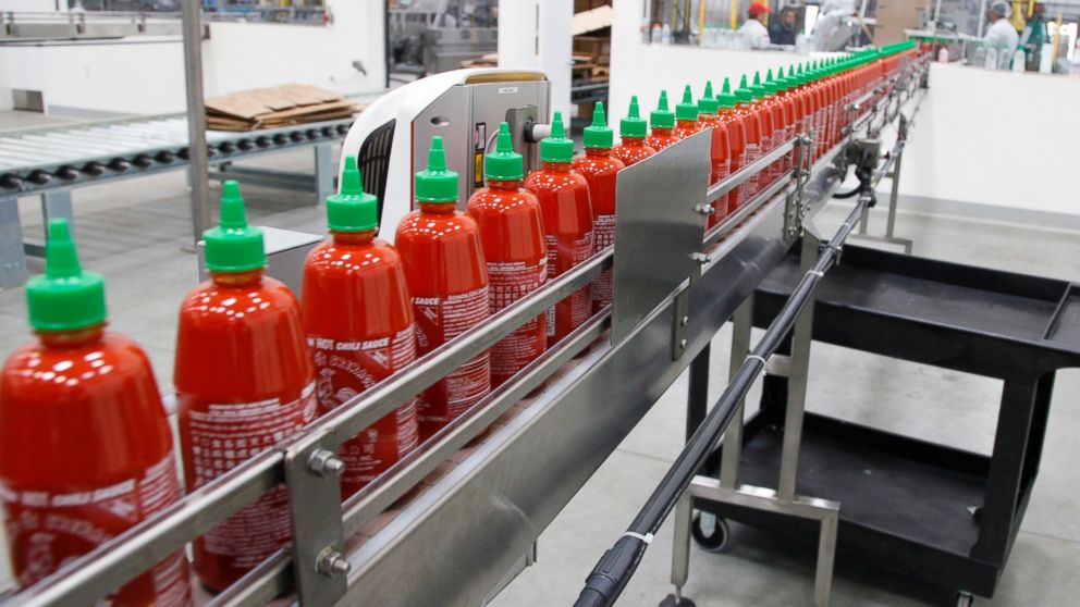 Sriracha chili sauce moves along a production line during at the Huy Fong Foods factory in Irwindale, Calif., Oct. 29, 2013. 