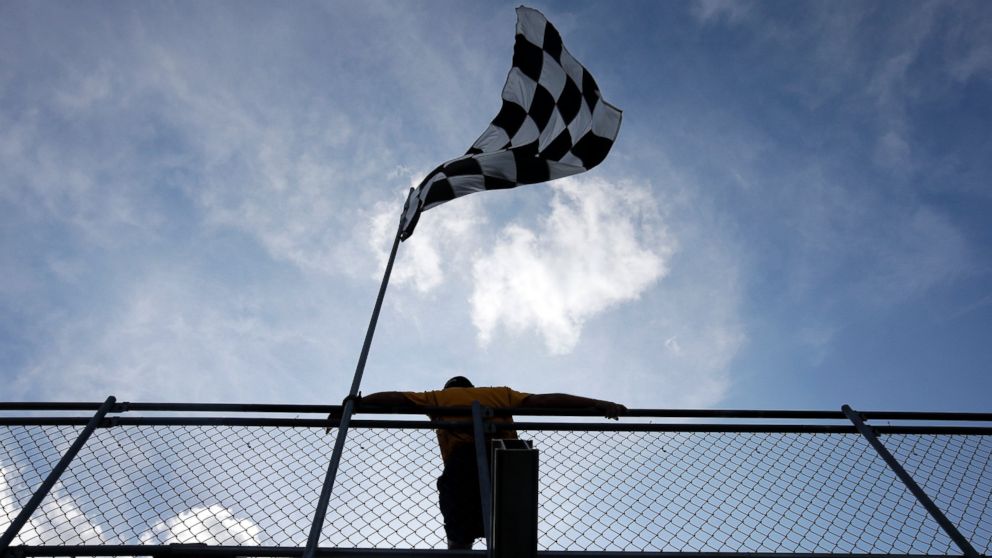 A fan watches a practice session for the Indianapolis 500 auto race at Indianapolis Motor Speedway in Indianapolis on May 18, 2015.  