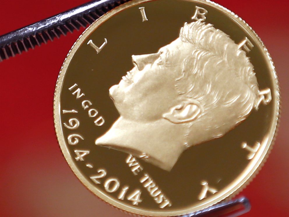 PHOTO: A newly-stamped gold coin of President John F. Kennedy is examined at the U.S. Mint at West Point on July 22, 2014 in West Point, N.Y. 