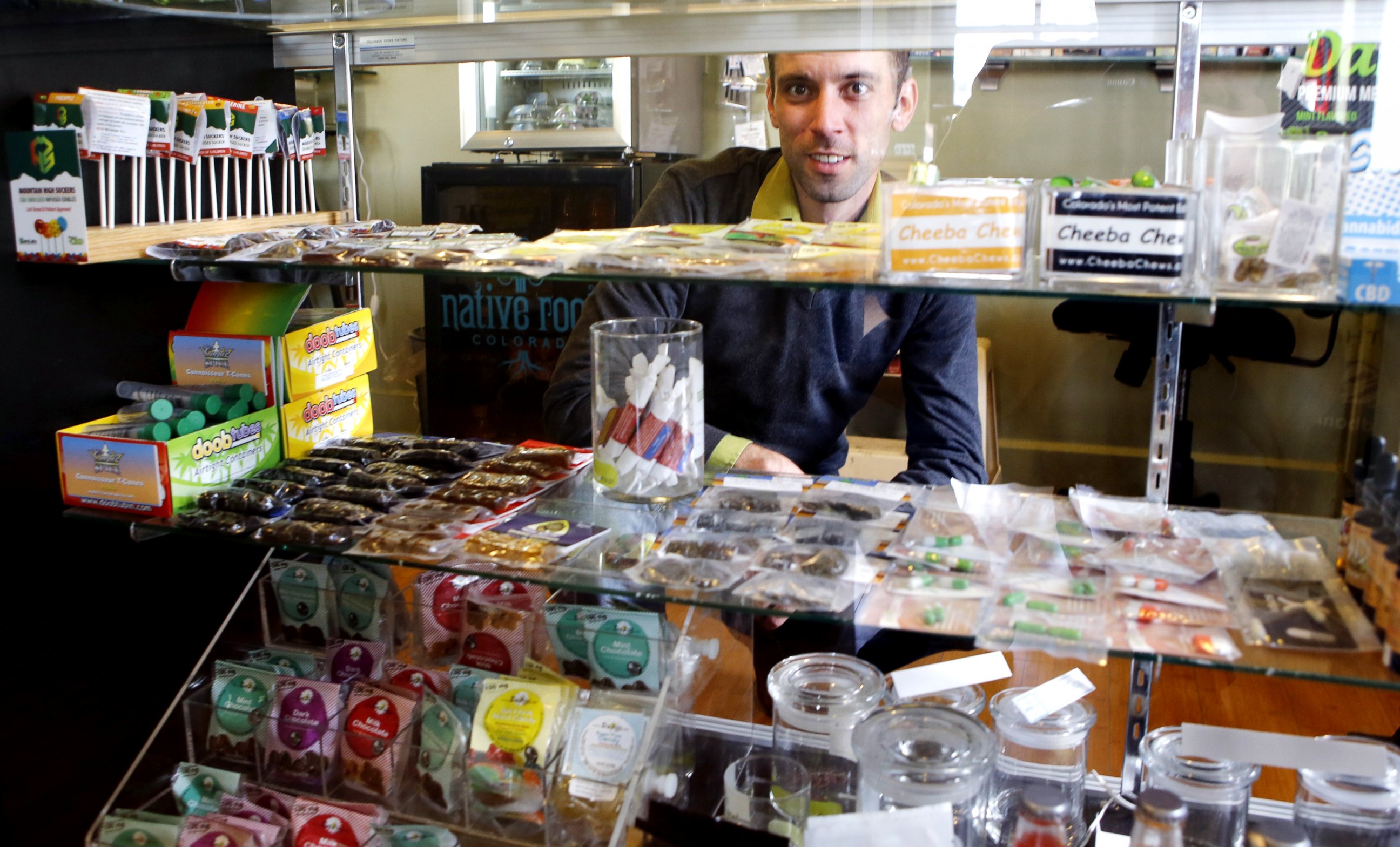 PHOTO: This  April 11, 2013 photo shows Matt Brown, co-owner of Denver's new "My 420 Tours," looking over a sampling of marijuana edibles at a dispensary in Denver.