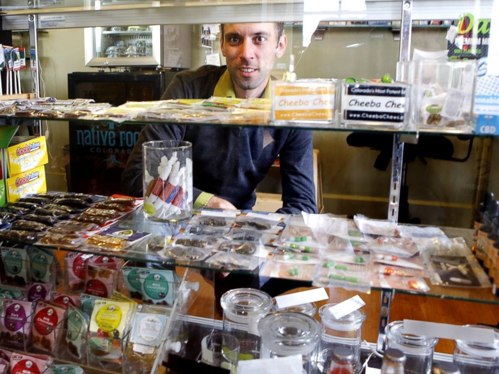 PHOTO: This April 11, 2013 photo shows Matt Brown, co-owner of Denvers new My 420 Tours, looking over a sampling of marijuana edibles at a dispensary in Denver.