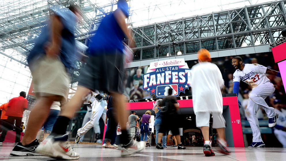 People walk into New York's Javits Convention Center during the All-Star FanFest, July 13, 2013.