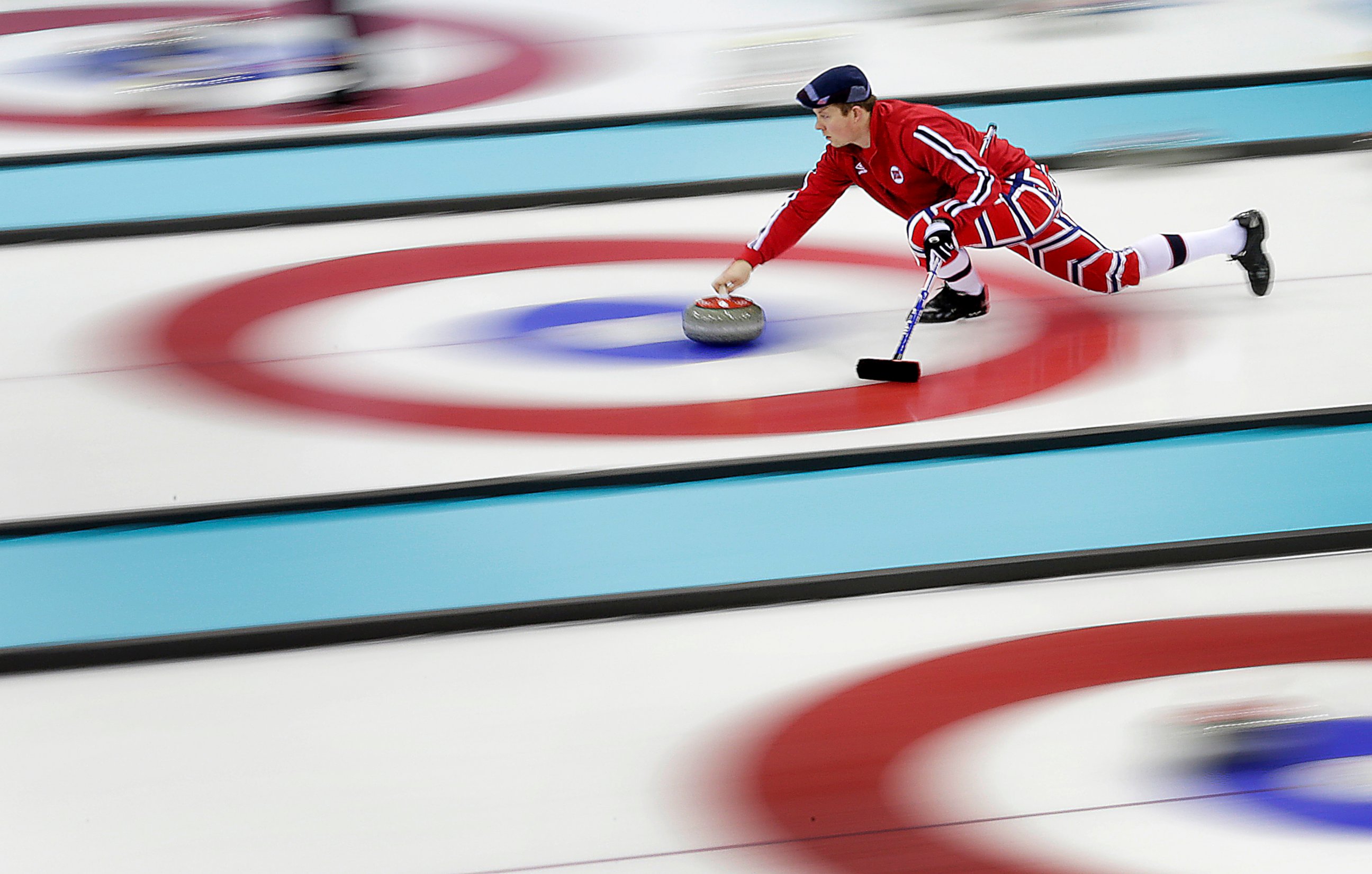 PHOTO: Norway's Christoffer Svae delivers the stone during the men's curling training session at the 2014 Winter Olympics, Feb. 9, 2014, in Sochi, Russia.