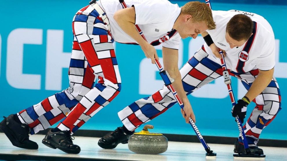 PHOTO: Norway's Haavard Vad Petersson, left, and Christoffer Svae sweep during men's curling competition against Team USA at the 2014 Winter Olympics, Feb. 10, 2014, in Sochi, Russia.