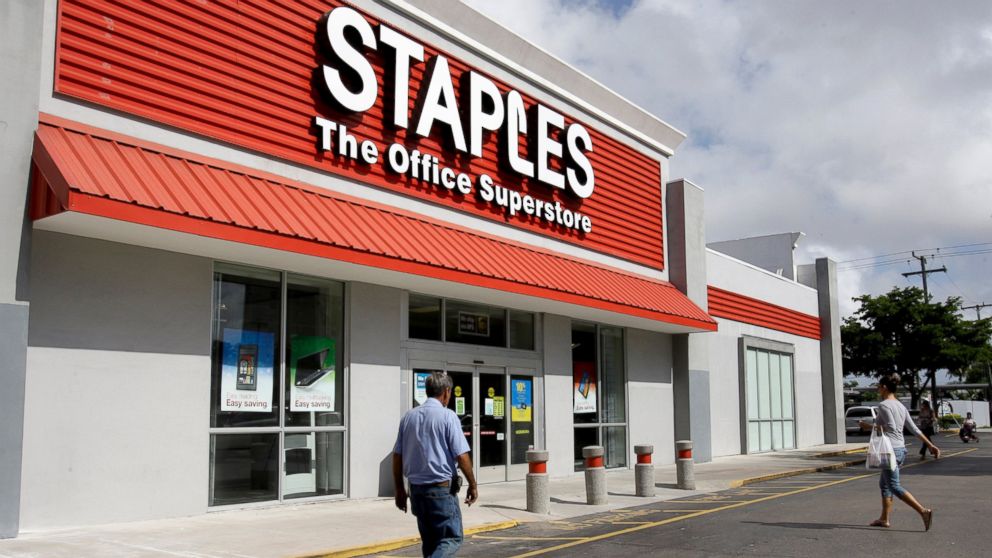 Customers enter Staples office supply store in Miami, in this Nov. 15, 2011, file photo.