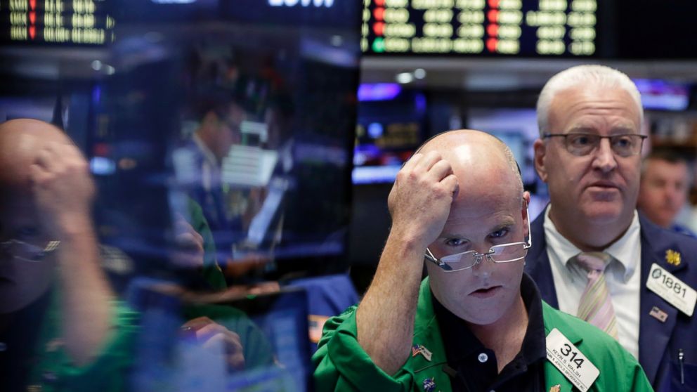 Trader Kevin Walsh, second from right, works on the floor of the New York Stock Exchange, June 24, 2016.