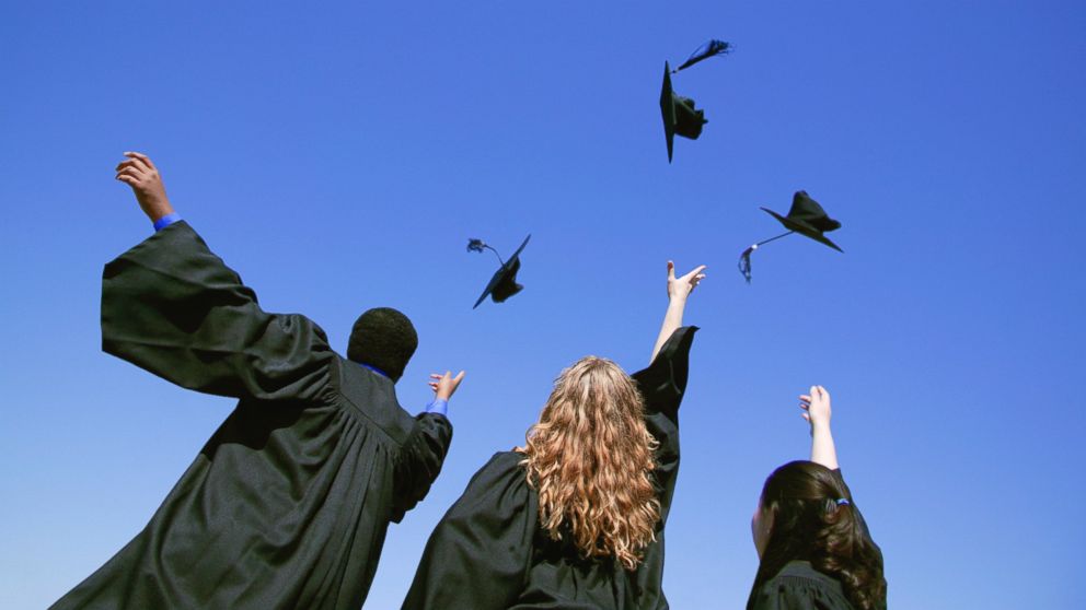 Graduates tossing their caps up in the air after graduation in this undated photo.