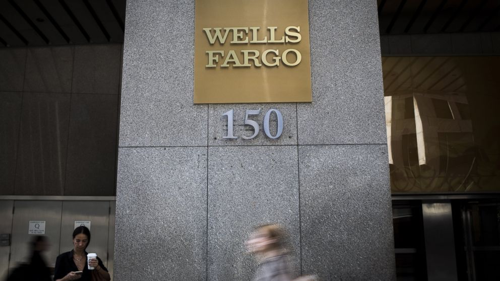 Pedestrians walk past the Wells Fargo & Co. office in New York City, on Oct. 6, 2016. 