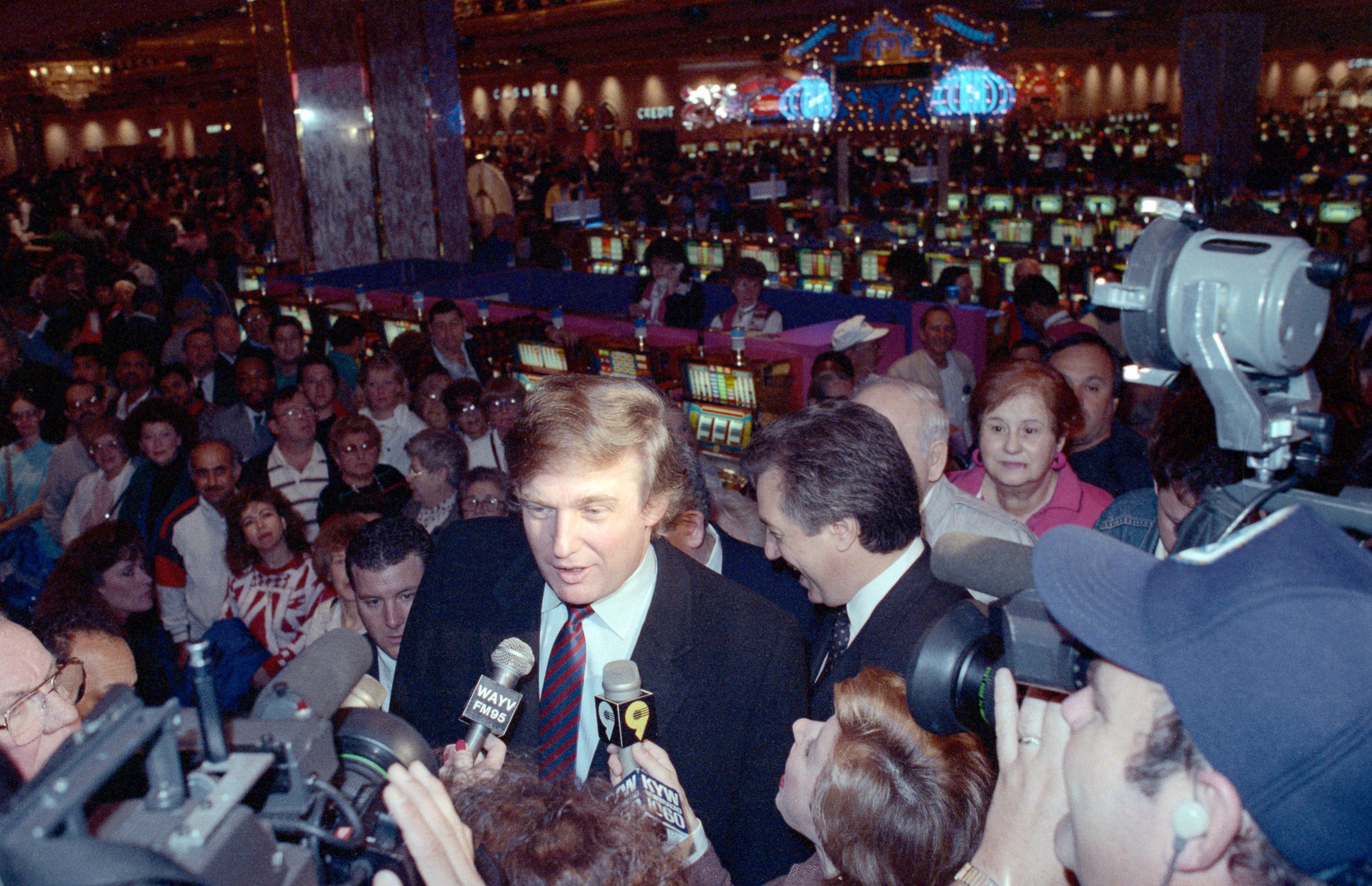 PHOTO: Donald Trump discusses his new casino, the Taj Mahal, from in front of a sea of slot machines.