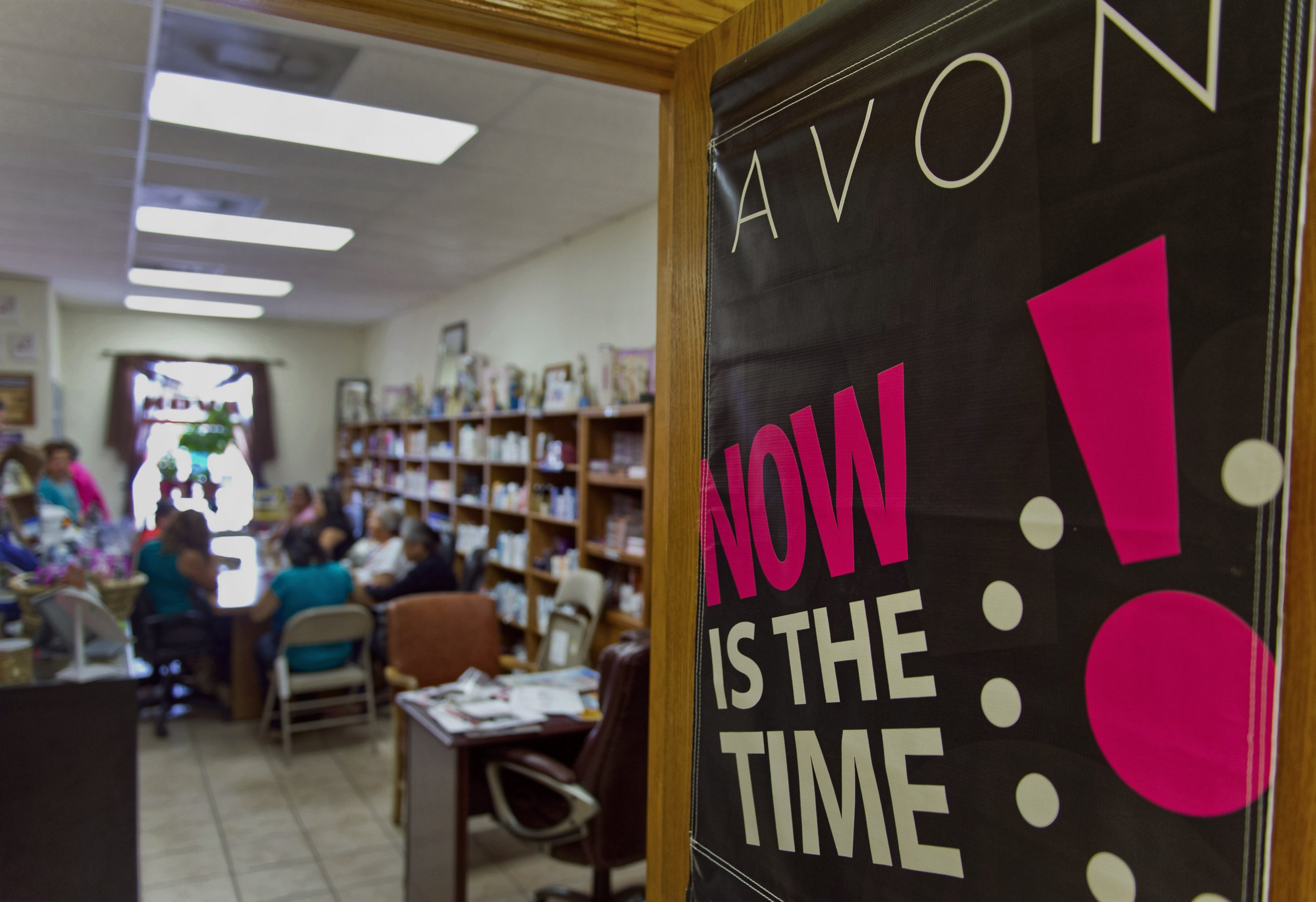 PHOTO: Avon Products Inc. signage is displayed on a door during a weekly sales meeting on Aug. 28, 2014 in McAllen, Texas.