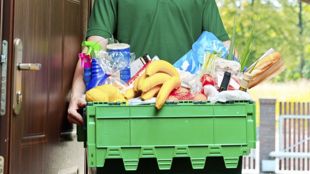A man delivering groceries to a home is pictured in this stock image.