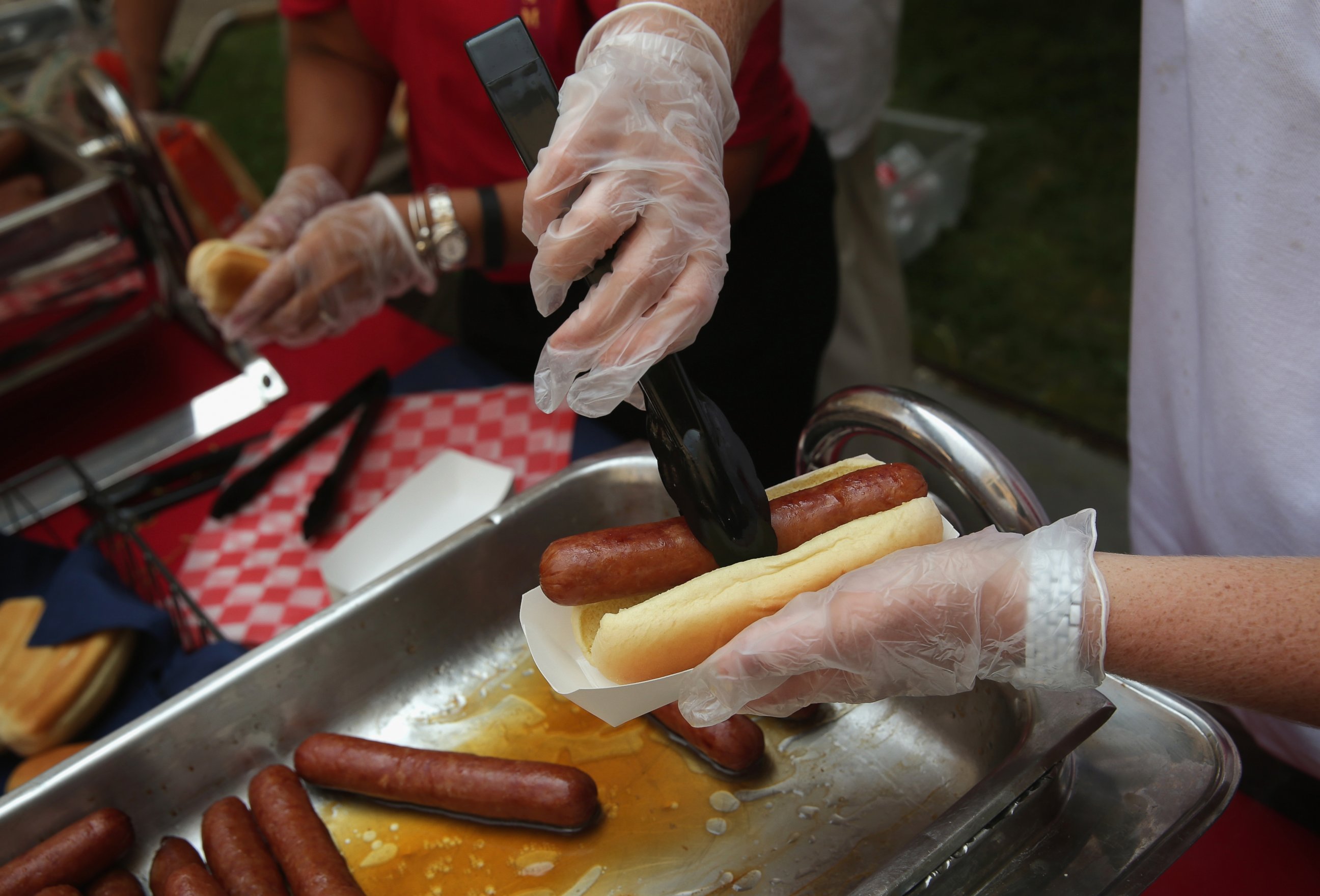 PHOTO: Hotdogs are handed out during the annual Capitol Hill Hot Dog Lunch at the courtyard of Rayburn House Office Building, July 23, 2014 on Capitol Hill in Washington.