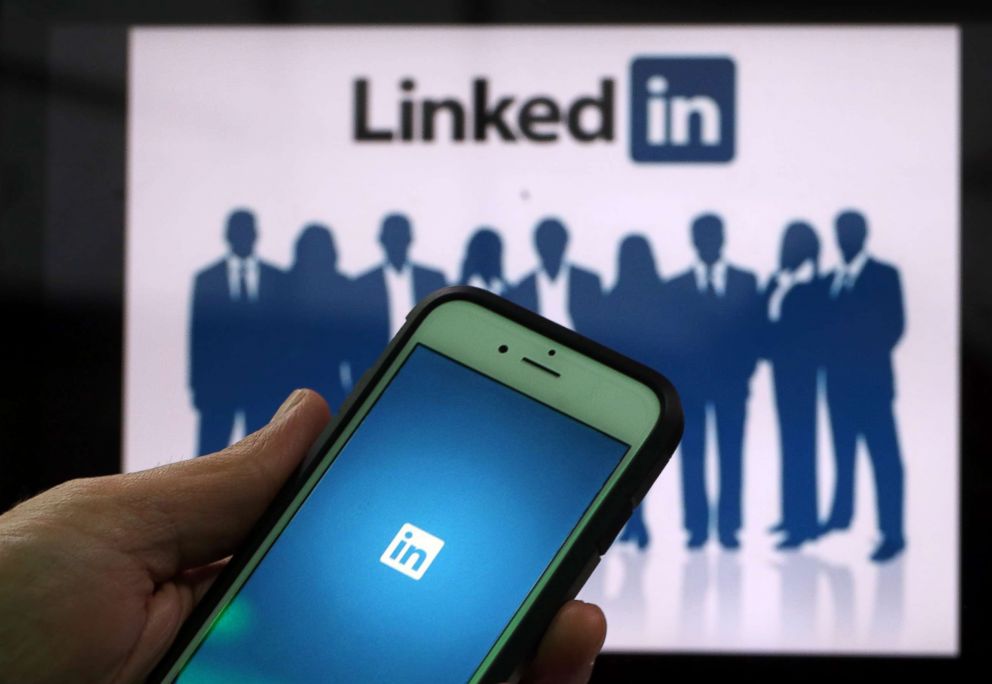 PHOTO: The LinkedIn Corp. logo is displayed on the screens of an iPhone and a laptop, May, 15, 2015, in London.