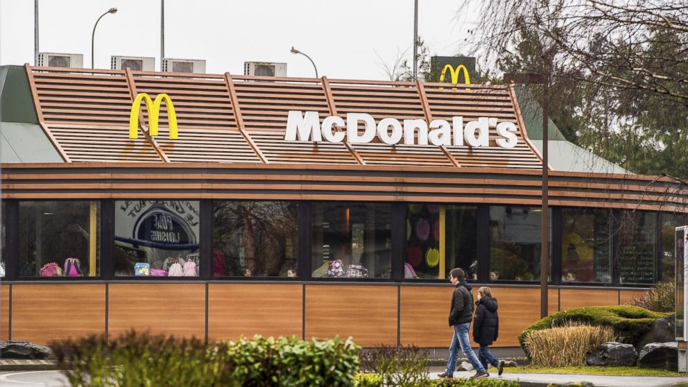 PHOTO: People walk past a McDonald's fast-food outlet, on Feb. 26, 2015, in northern France. 
