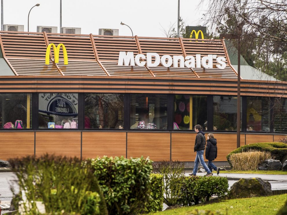 PHOTO: People walk past a McDonalds fast-food outlet, on Feb. 26, 2015, in northern France.