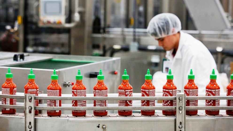 PHOTO: Bottles of the Sriracha hot sauce travel down a conveyor belt to be boxed for shipment at the Huy Fong Foods Inc. facility in Irwindale, Calif., Nov. 11, 2013.