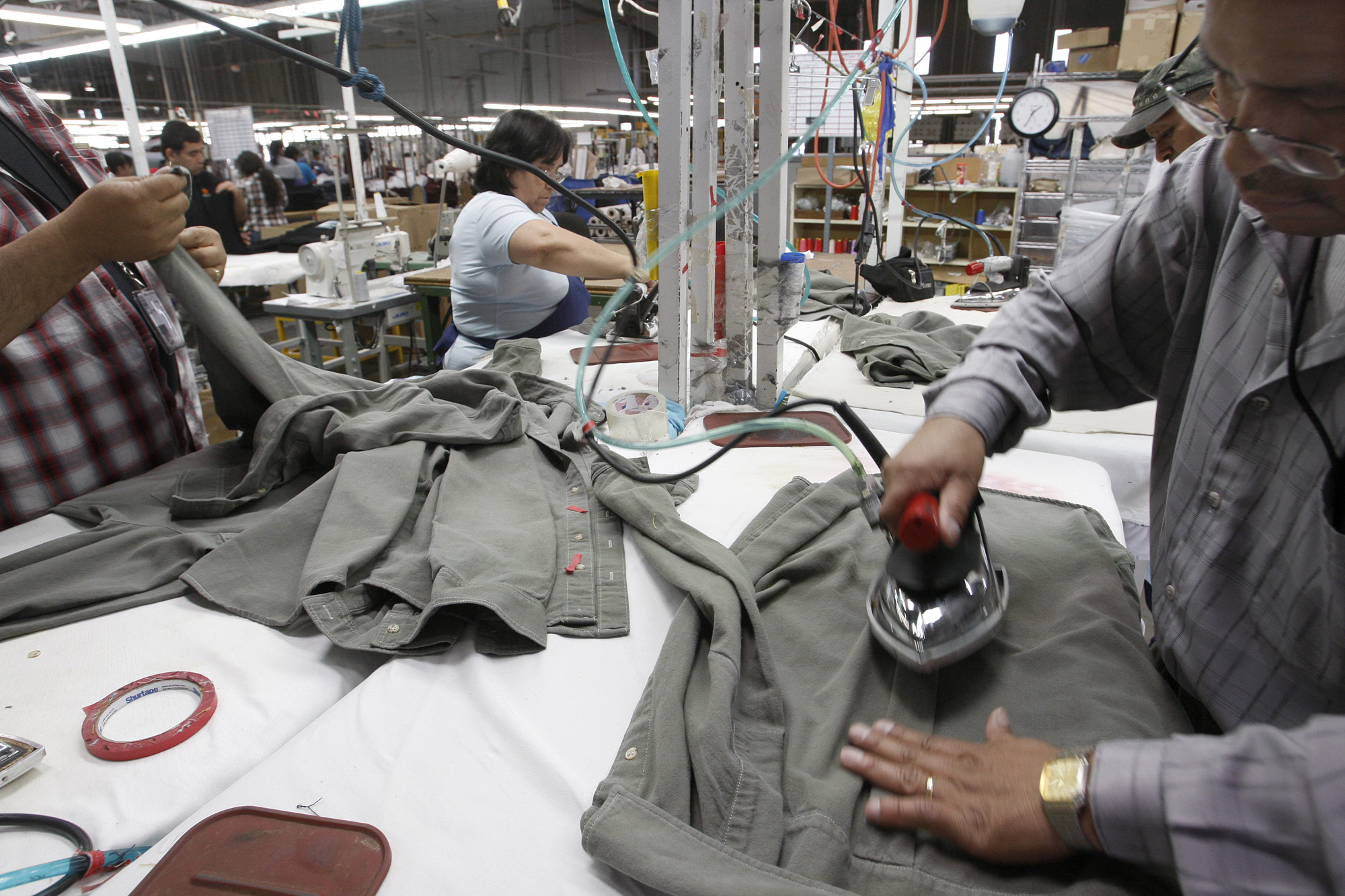 PHOTO: Workers iron shirts at the American Apparel factory in downtown Los Angeles, April 3, 2012.