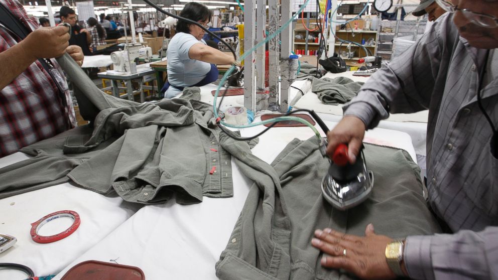 PHOTO: Workers iron shirts at the American Apparel factory in downtown Los Angeles, April 3, 2012.
