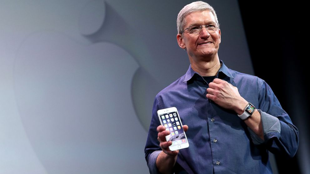 Apple CEO Tim Cook shows off the new iPhone 6 and the Apple Watch during an Apple special event at the Flint Center for the Performing Arts, Sept. 9, 2014, in Cupertino, Calif. 