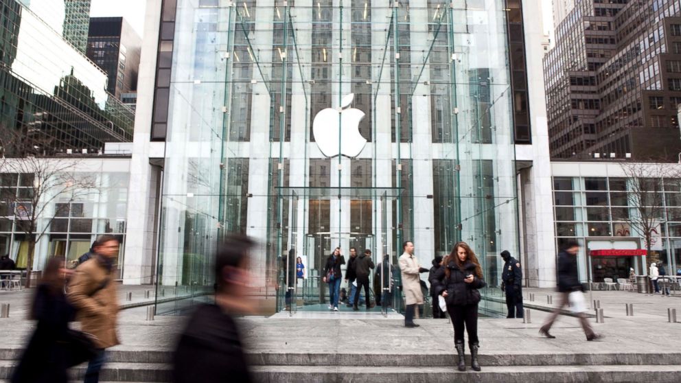 Pedestrians walk past the Apple Inc. Store on Fifth Avenue in New York, Jan. 11, 2011. 