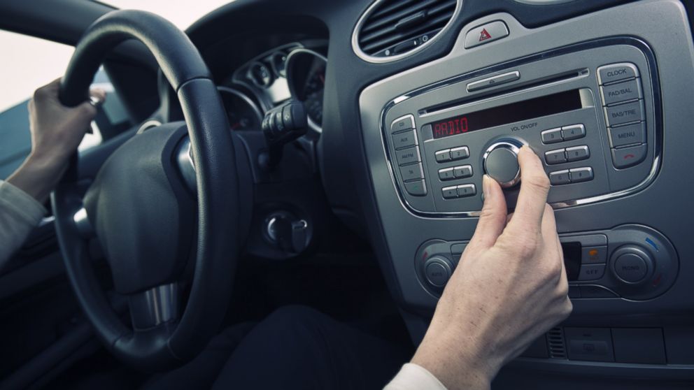 PHOTO: A man adjust the volume of a car stereo in this stock image.