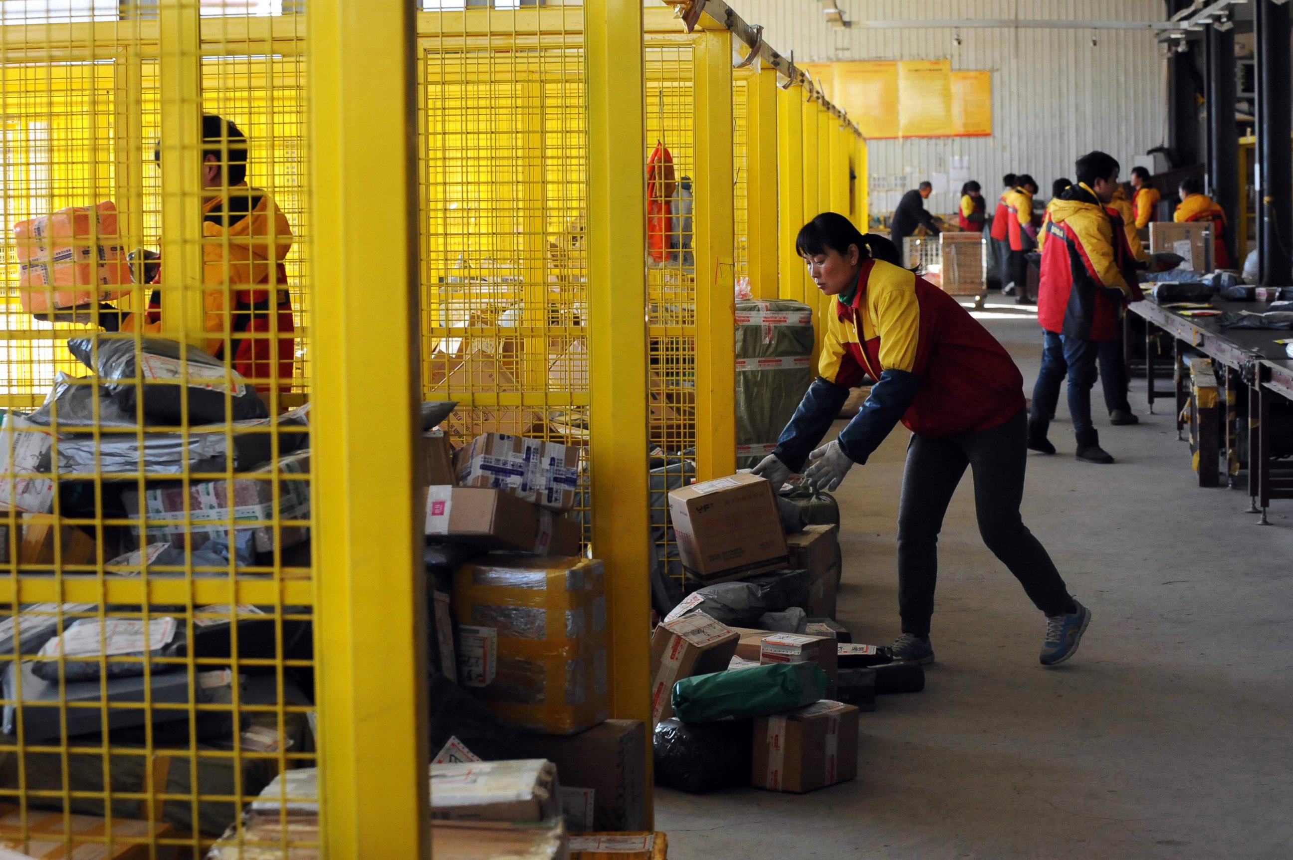 PHOTO: Workers sort out packages at an express delivery company in Beijing, Nov. 12, 2013, after "Singles Day" e-tailer festival on Nov. 11.