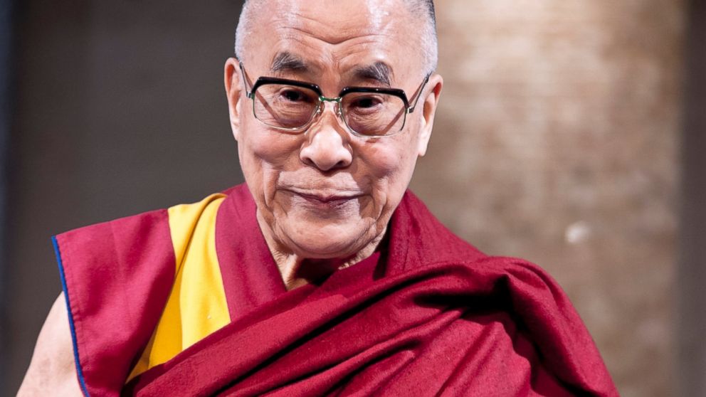 Tibetan spiritual leader the Dalai Lama is introduced to guests during "Dialogue in Tokyo" at Hotel Okura in Tokyo, Nov. 17, 2013.