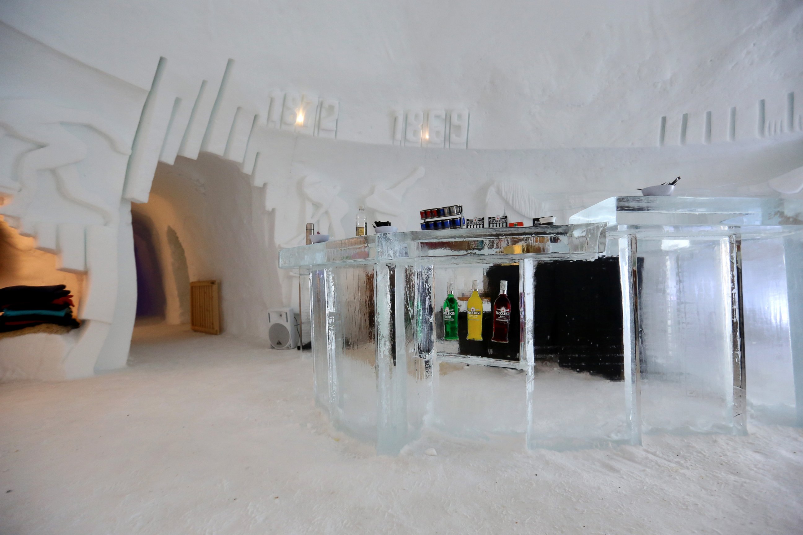 PHOTO: Bottles of red, green and yellow colored spirits sit encased in ice in the bar area at the luxury igloo ice hotel, operated by Iglu-Dorf, on the Parsenn mountain above the town of Davos, Switzerland on Jan. 20, 2015.