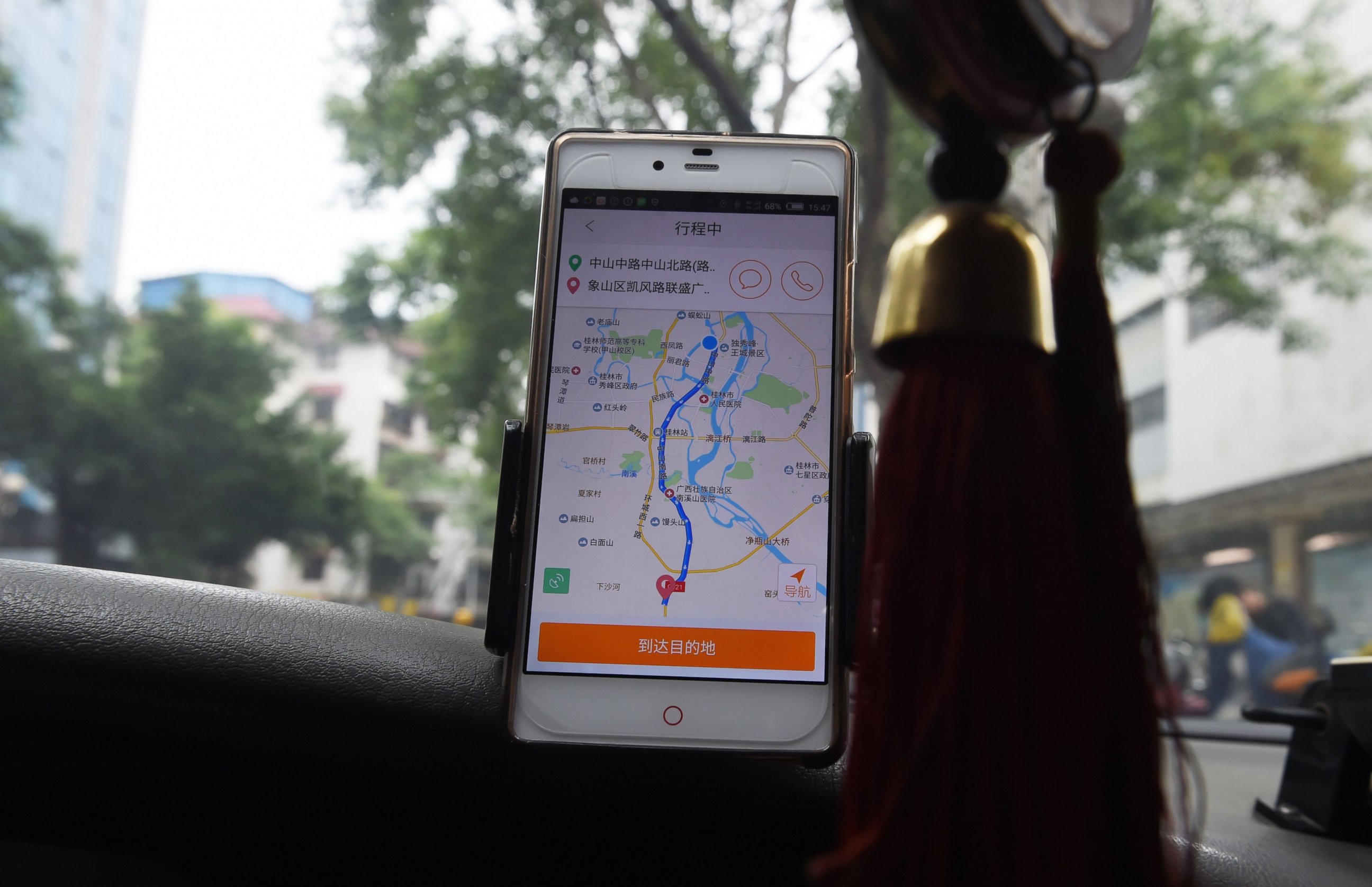 PHOTO: A taxi driver uses the Didi Chuxing app while driving along a street in Guilin, in China's southern Guangxi region on May 13, 2016.