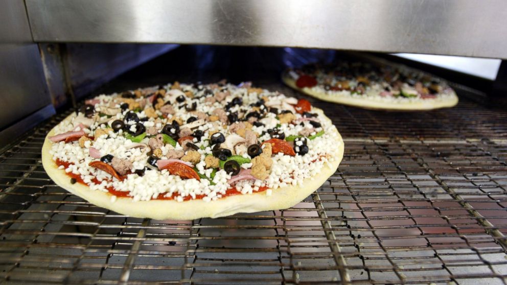 PHOTO:Domino's Pizza is seen baking in an oven in Miami, Fla., April 14, 2004.