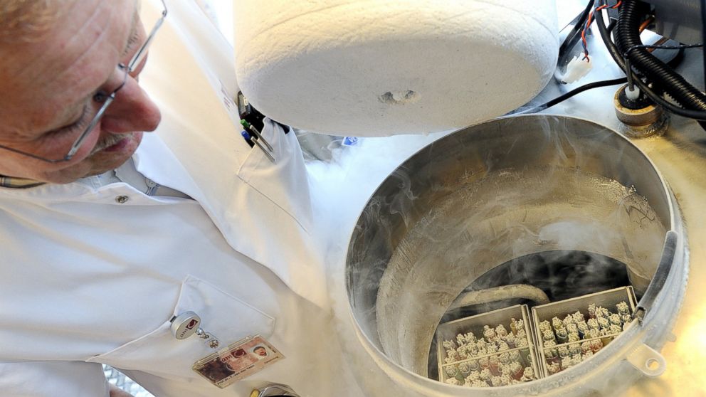 A technician opens a vessel containing women's frozen egg cells in Amsterdam, Netherlands, April 6, 2011.