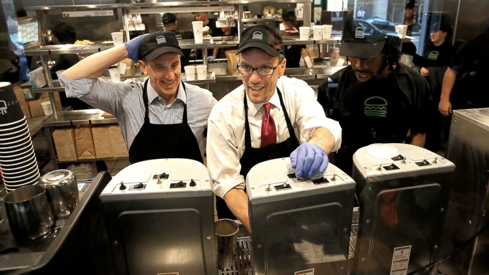 U.S. Labor Secretary Thomas Perez, center, talks with Shake Shack employee Jamelle Bland, right, while making a milkshake during a tour of the restaurant with Shake Shack CEO Randy Garutti, left, March 21, 2014, in Washington. Perez toured the restaurant to participate in a discussion on the federal minimum wage, and the Obama administration's efforts to raise the minimum wage to $10.10.