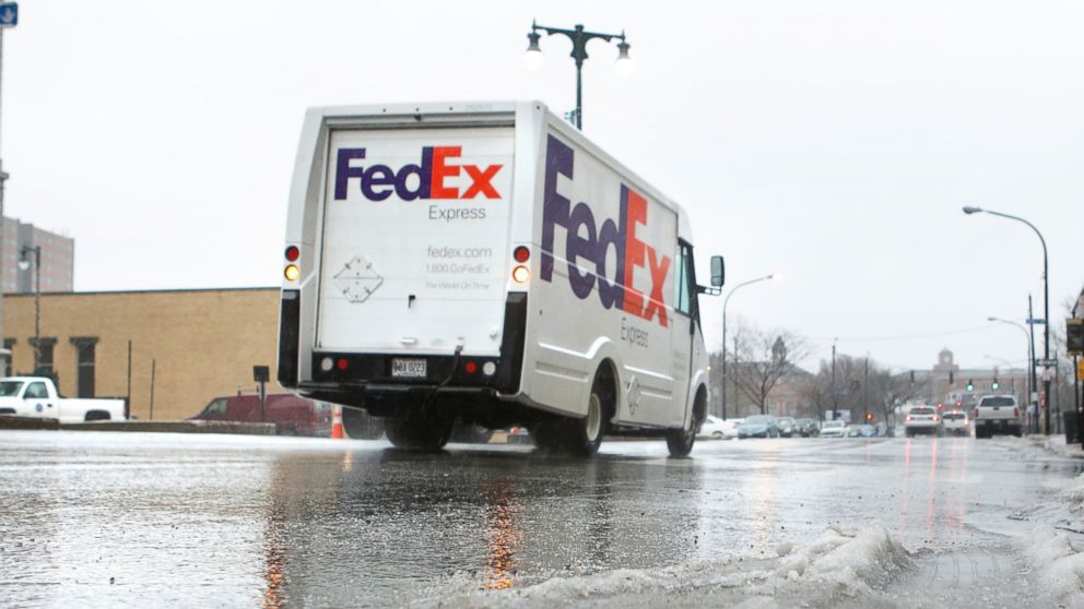 A FedEx delivery truck travels along Congress Street in Portland, Dec. 10, 2014.