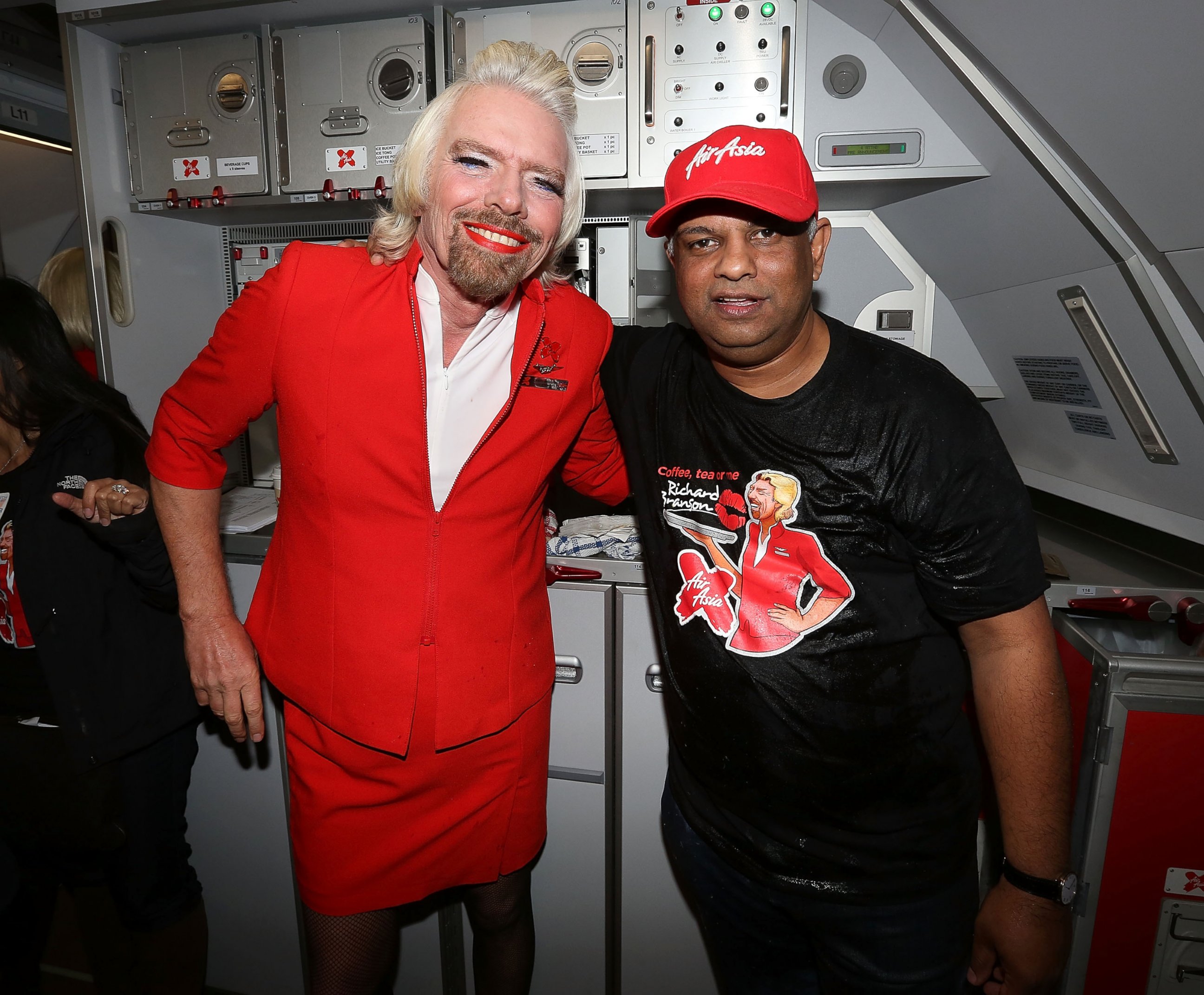 PHOTO: Sir Richard Branson and AirAsia CEO Tony Fernandes on board a flight to Kuala Lumpur at Perth International Airport on May 12, 2013, in Perth, Australia. 