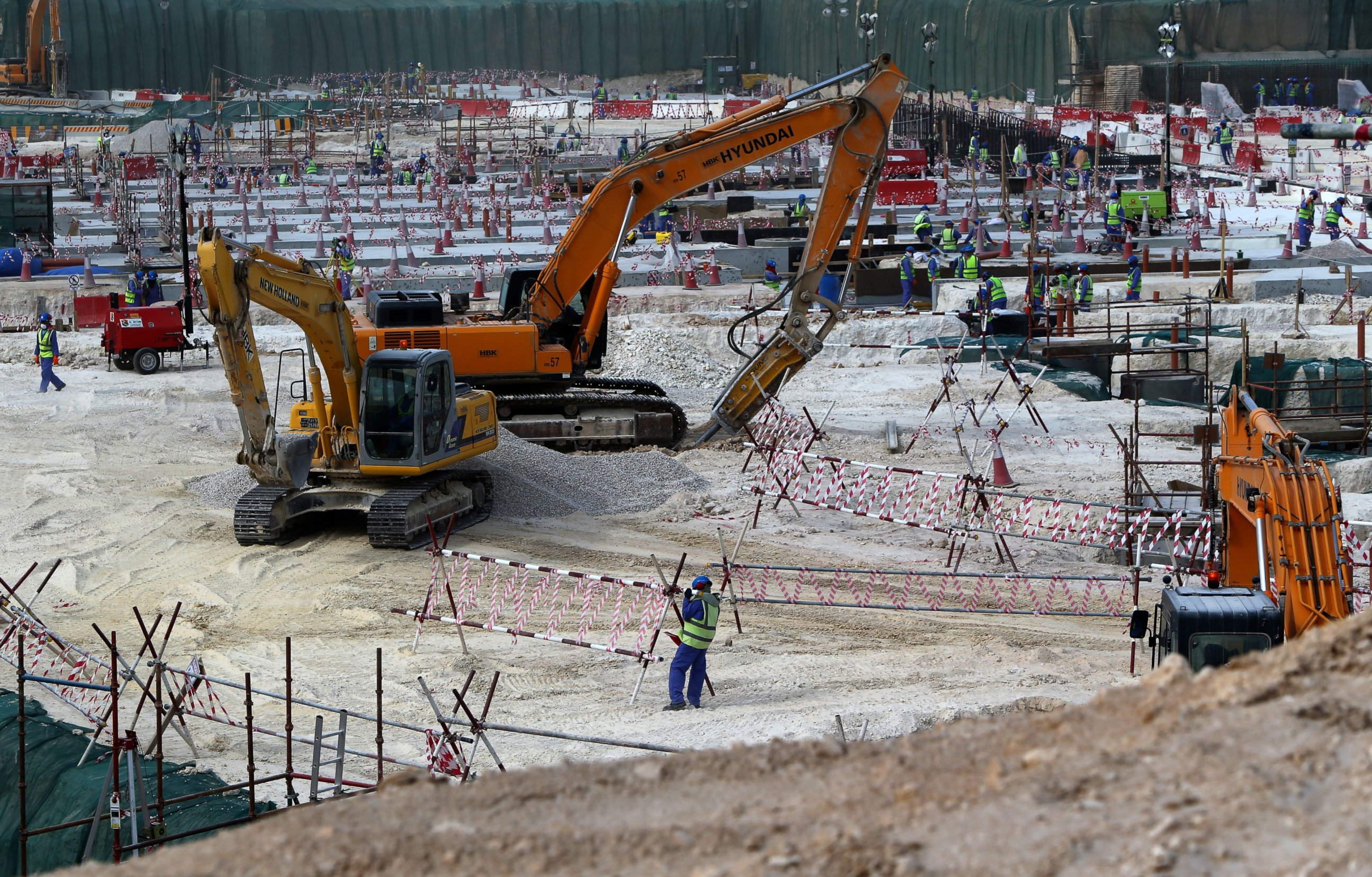 PHOTO: Foreign laborers work at the construction site of the al-Wakrah football stadium, one of the Qatar's 2022 World Cup stadiums, on May 4, 2015, in Doha's Al-Wakrah southern suburbs. 