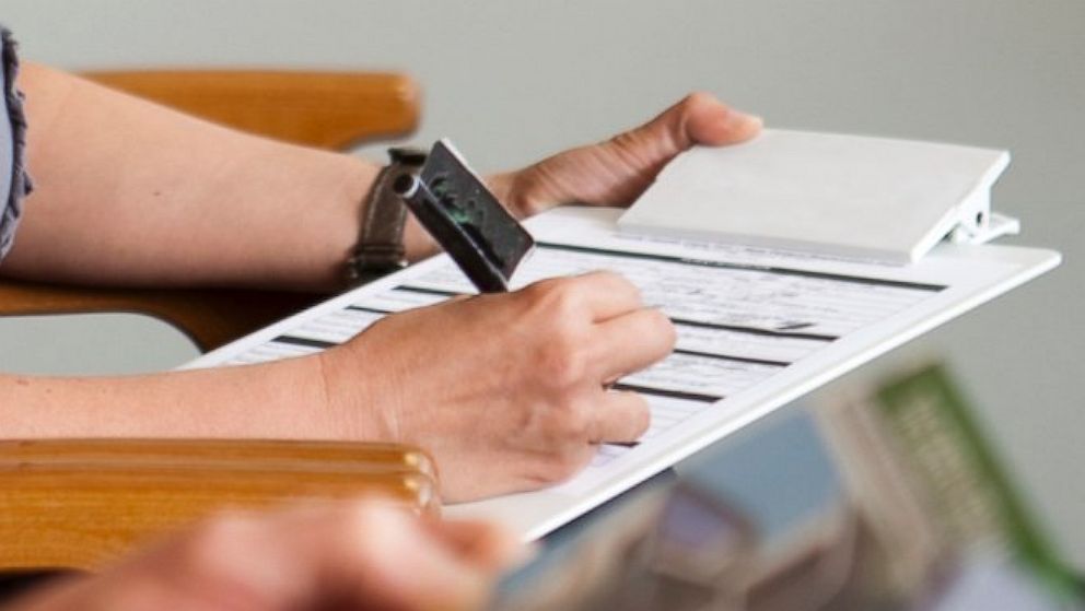 A patient fills out a health insurance form at a doctor's office in this file photo. 