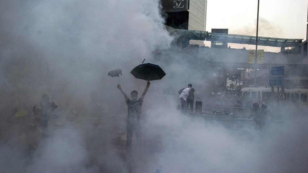 A pro-democracy demonstrator gestures after police fired tear gas towards protesters near the Hong Kong government headquarters, Sept. 28, 2014.