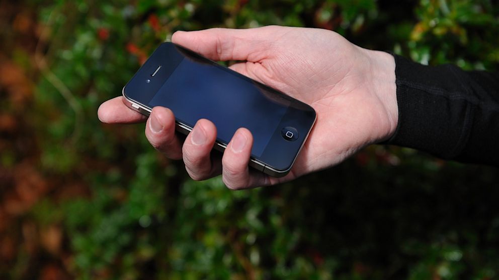 A man holds an Apple iPhone 4, Dec. 16, 2010.