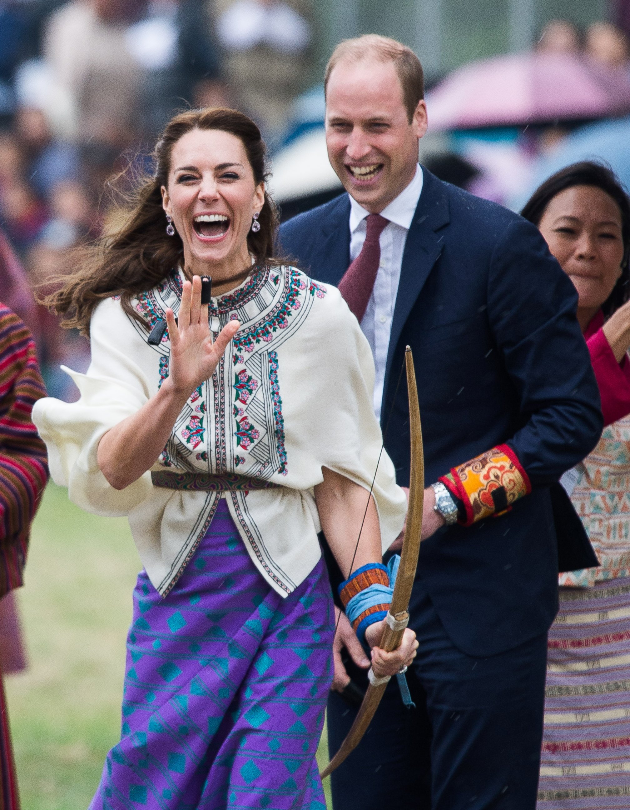 PHOTO: Catherine, Duchess of Cambridge and Prince William react as they take part in archery at Thimphu's open-air archery venue, April 14, 2016, in Thimphu, Bhutan.