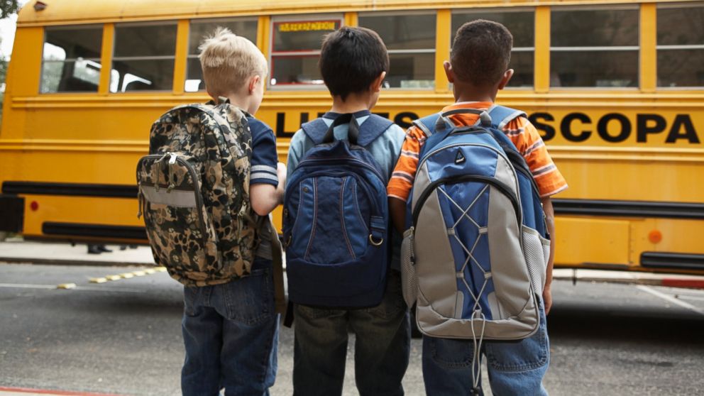 Kid store holding backpack