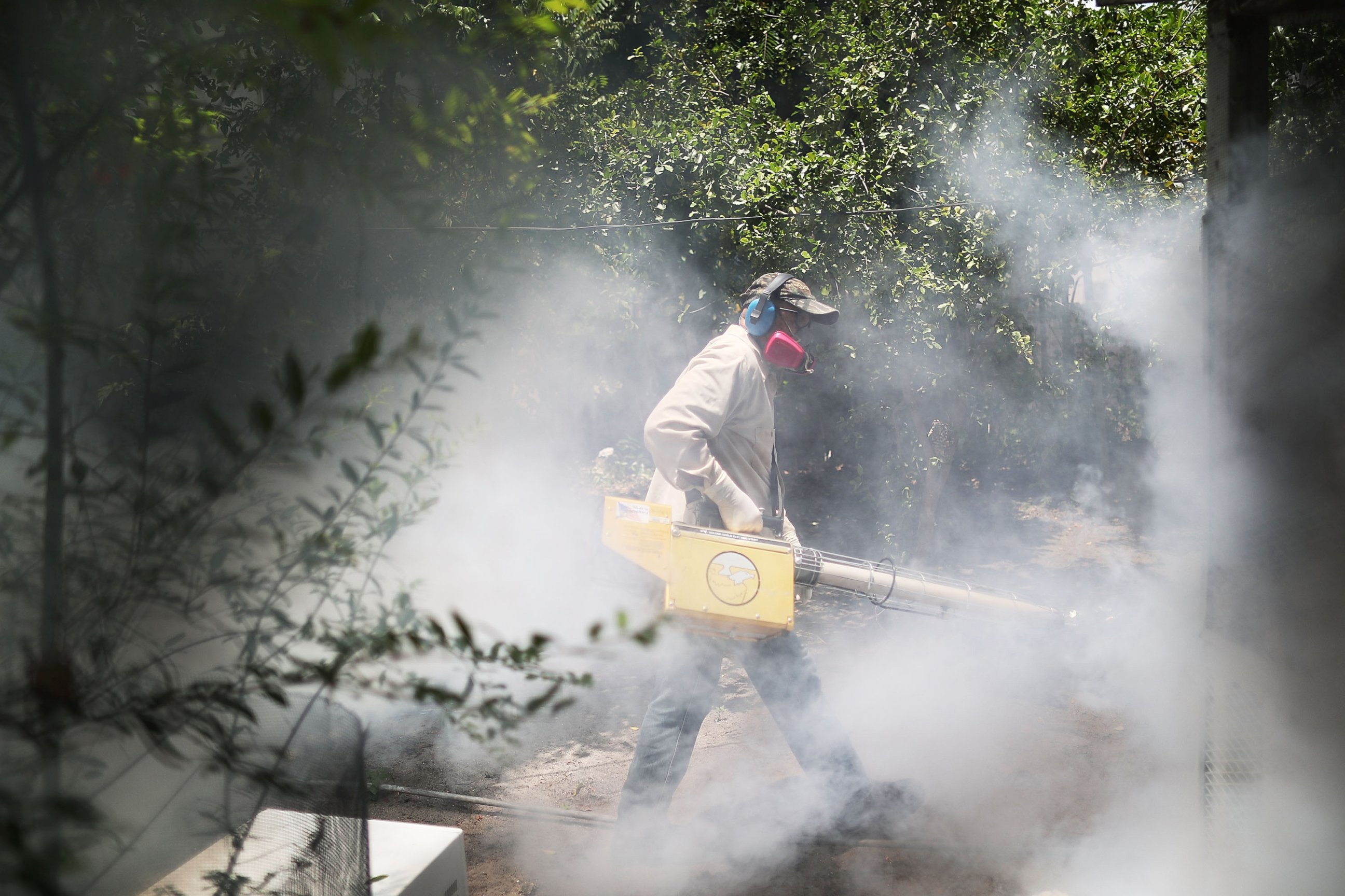PHOTO: Carlos Varas, a Miami-Dade County mosquito control inspector, uses a Golden Eagle blower to spray pesticide to kill mosquitoes in the Wynwood neighborhood as the county fights to control the Zika virus outbreak, Aug. 2, 2016 in Miami.