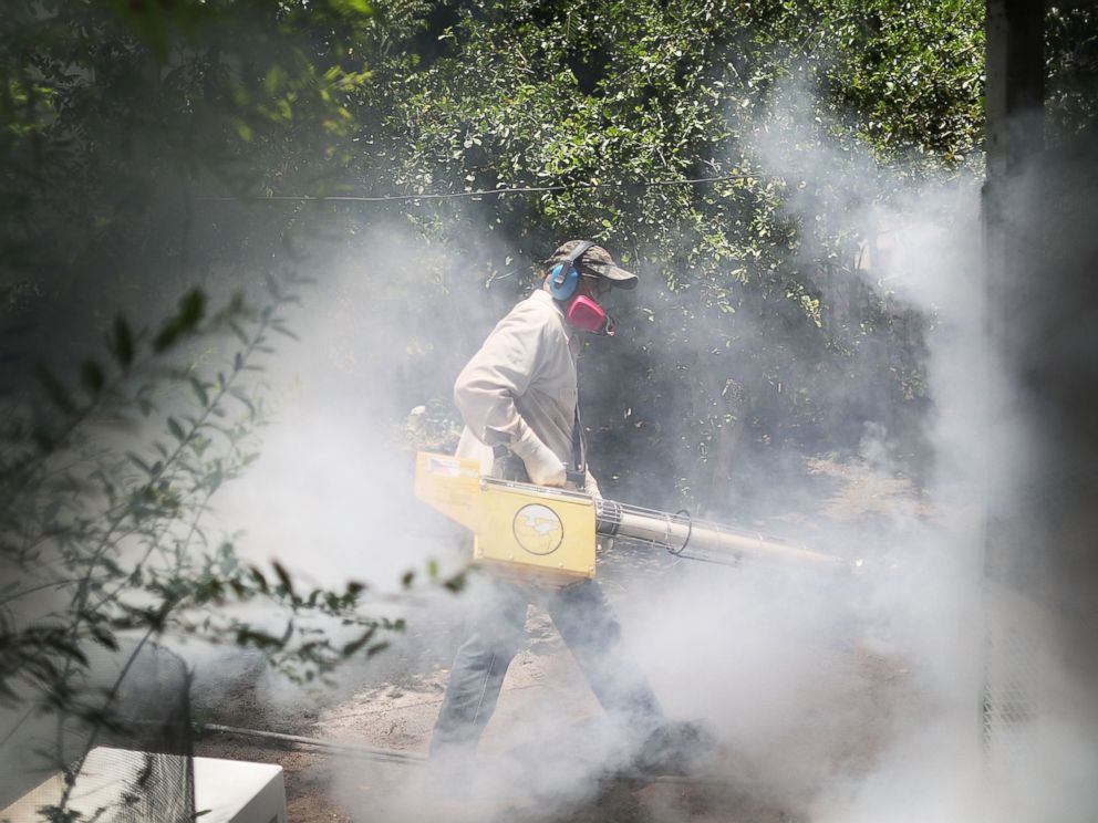 PHOTO: Carlos Varas, a Miami-Dade County mosquito control inspector, uses a Golden Eagle blower to spray pesticide to kill mosquitoes in the Wynwood neighborhood as the county fights to control the Zika virus outbreak, Aug. 2, 2016 in Miami.